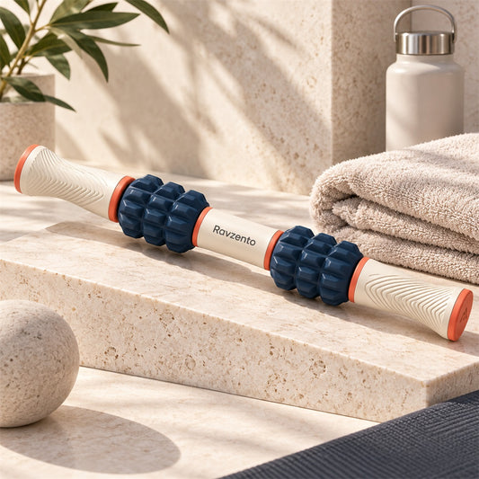 Ravzento dual-handle muscle roller on a warm studio surface