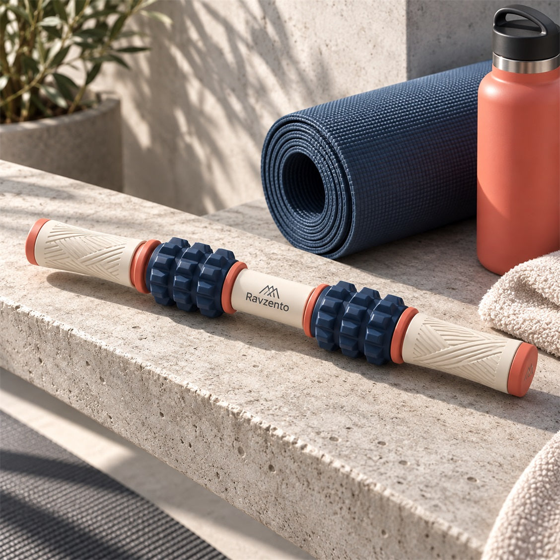 Ravzento textured muscle roller beside a yoga mat and towels